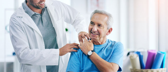 Doctors hand on patients shoulder